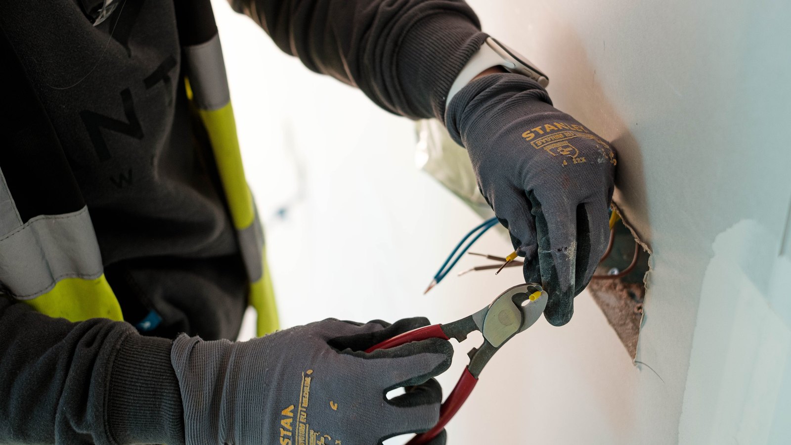Electrician cutting conductors during an electrical installation